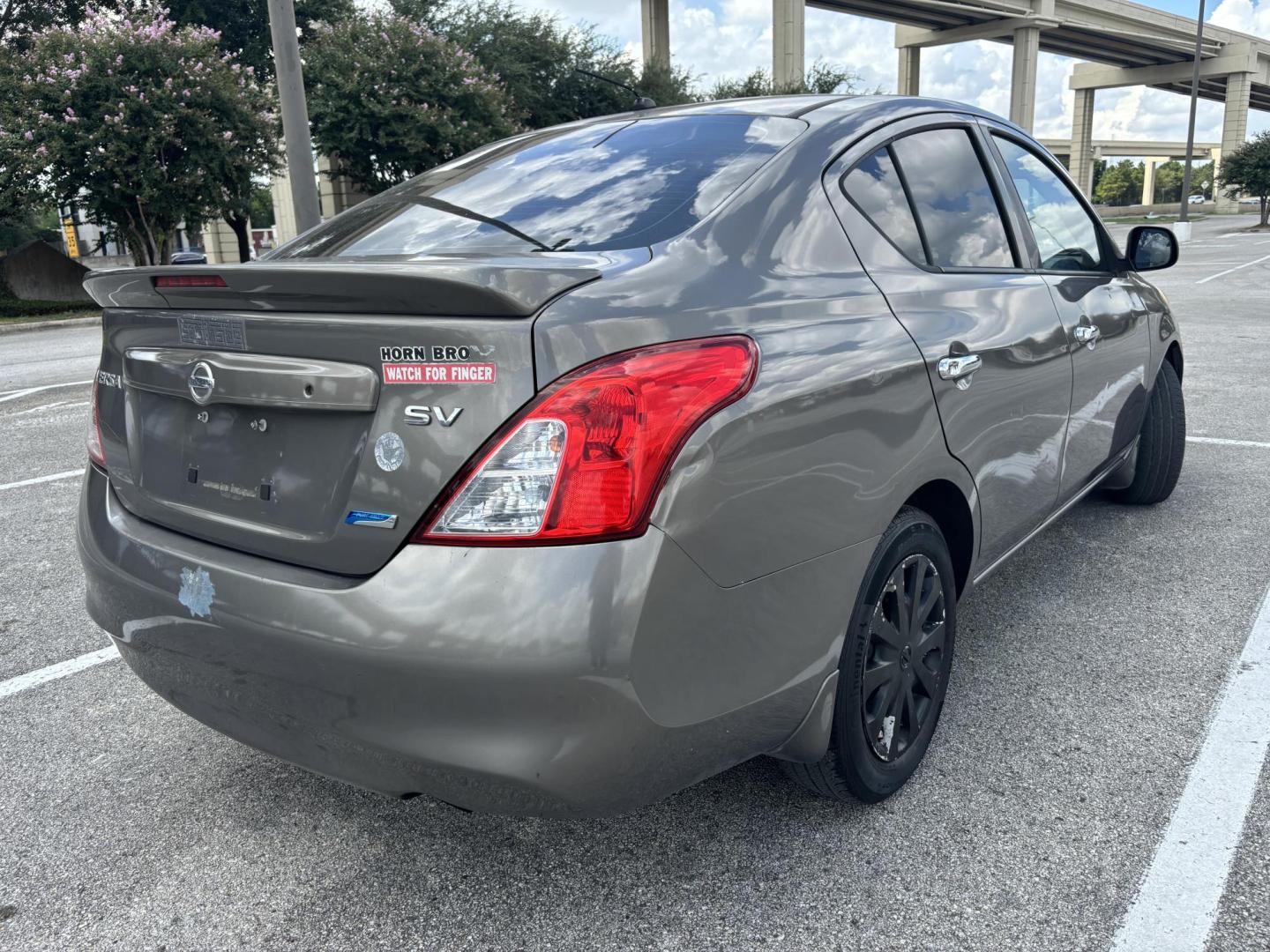 2013 Silver Nissan Versa 1.6 S 5M (3N1CN7AP7DL) with an 1.6L L4 DOHC 16V engine, 5-Speed Manual transmission, located at 5005 Telephone Rd., Houston, TX, 77087, (713) 641-0980, 29.690666, -95.298683 - Photo#4