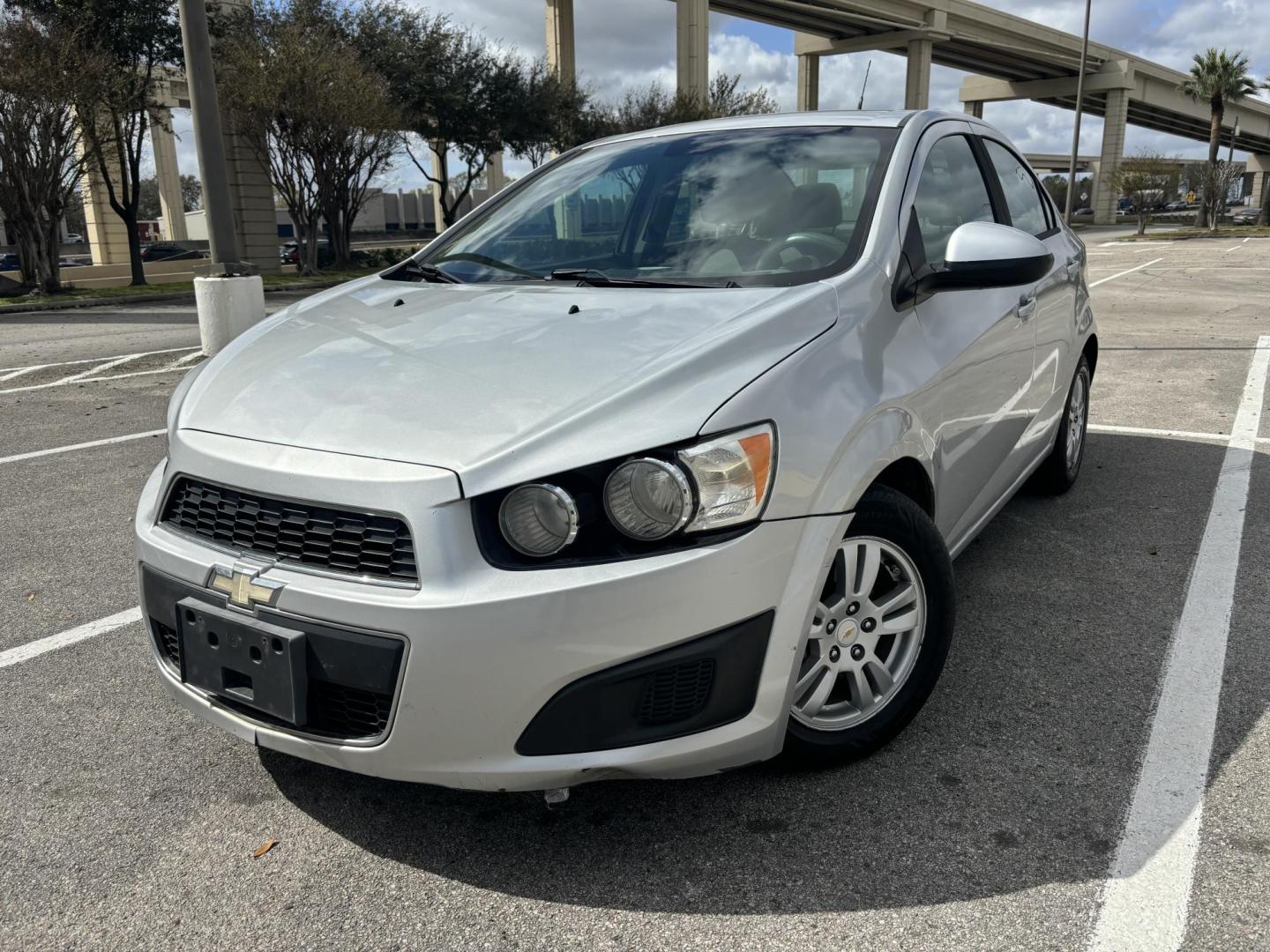 2012 silver Chevrolet Sonic 2LS Sedan (1G1JA5SH1C4) with an 1.8L L4 DOHC 24V FFV engine, 6-Speed Automatic transmission, located at 5005 Telephone Rd., Houston, TX, 77087, (713) 641-0980, 29.690666, -95.298683 - Photo#0