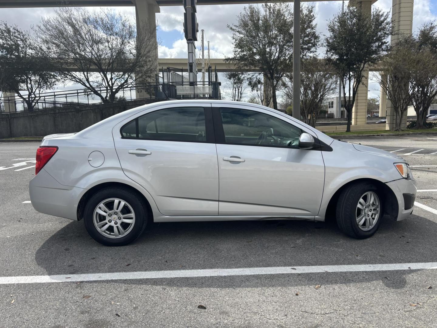 2012 silver Chevrolet Sonic 2LS Sedan (1G1JA5SH1C4) with an 1.8L L4 DOHC 24V FFV engine, 6-Speed Automatic transmission, located at 5005 Telephone Rd., Houston, TX, 77087, (713) 641-0980, 29.690666, -95.298683 - Photo#5