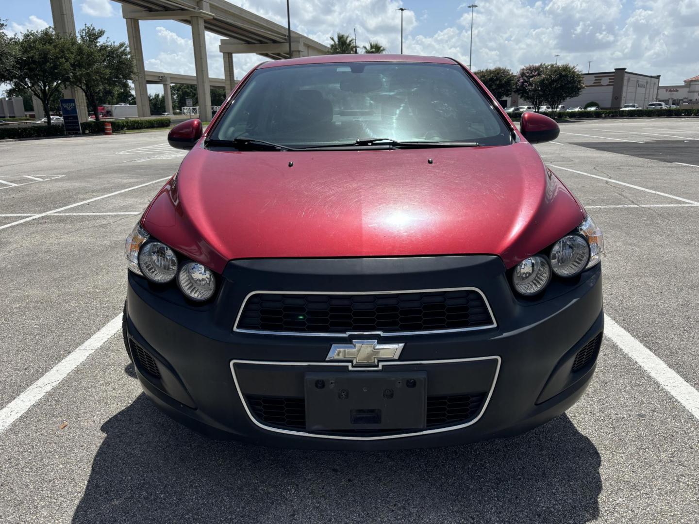 2014 Red Chevrolet Sonic LT Auto Sedan (1G1JC5SH5E4) with an 1.8L L4 DOHC 24V engine, 6-Speed Automatic transmission, located at 5005 Telephone Rd., Houston, TX, 77087, (713) 641-0980, 29.690666, -95.298683 - Photo#1