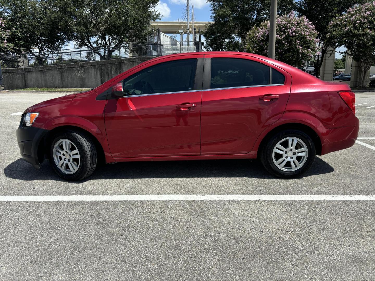 2014 Red Chevrolet Sonic LT Auto Sedan (1G1JC5SH5E4) with an 1.8L L4 DOHC 24V engine, 6-Speed Automatic transmission, located at 5005 Telephone Rd., Houston, TX, 77087, (713) 641-0980, 29.690666, -95.298683 - Photo#2