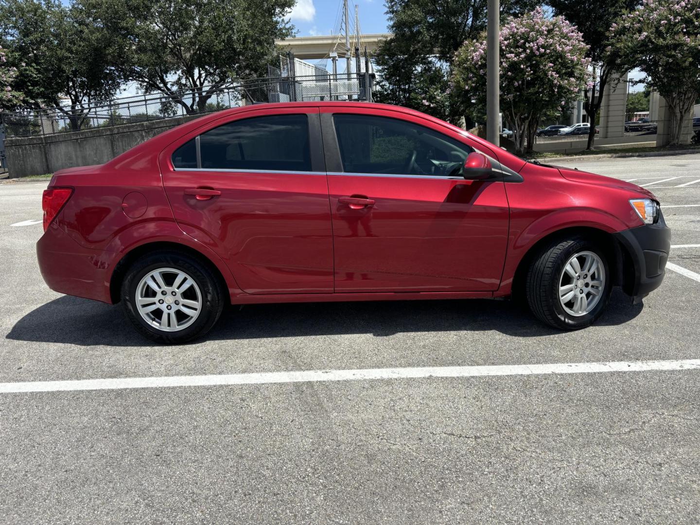 2014 Red Chevrolet Sonic LT Auto Sedan (1G1JC5SH5E4) with an 1.8L L4 DOHC 24V engine, 6-Speed Automatic transmission, located at 5005 Telephone Rd., Houston, TX, 77087, (713) 641-0980, 29.690666, -95.298683 - Photo#5