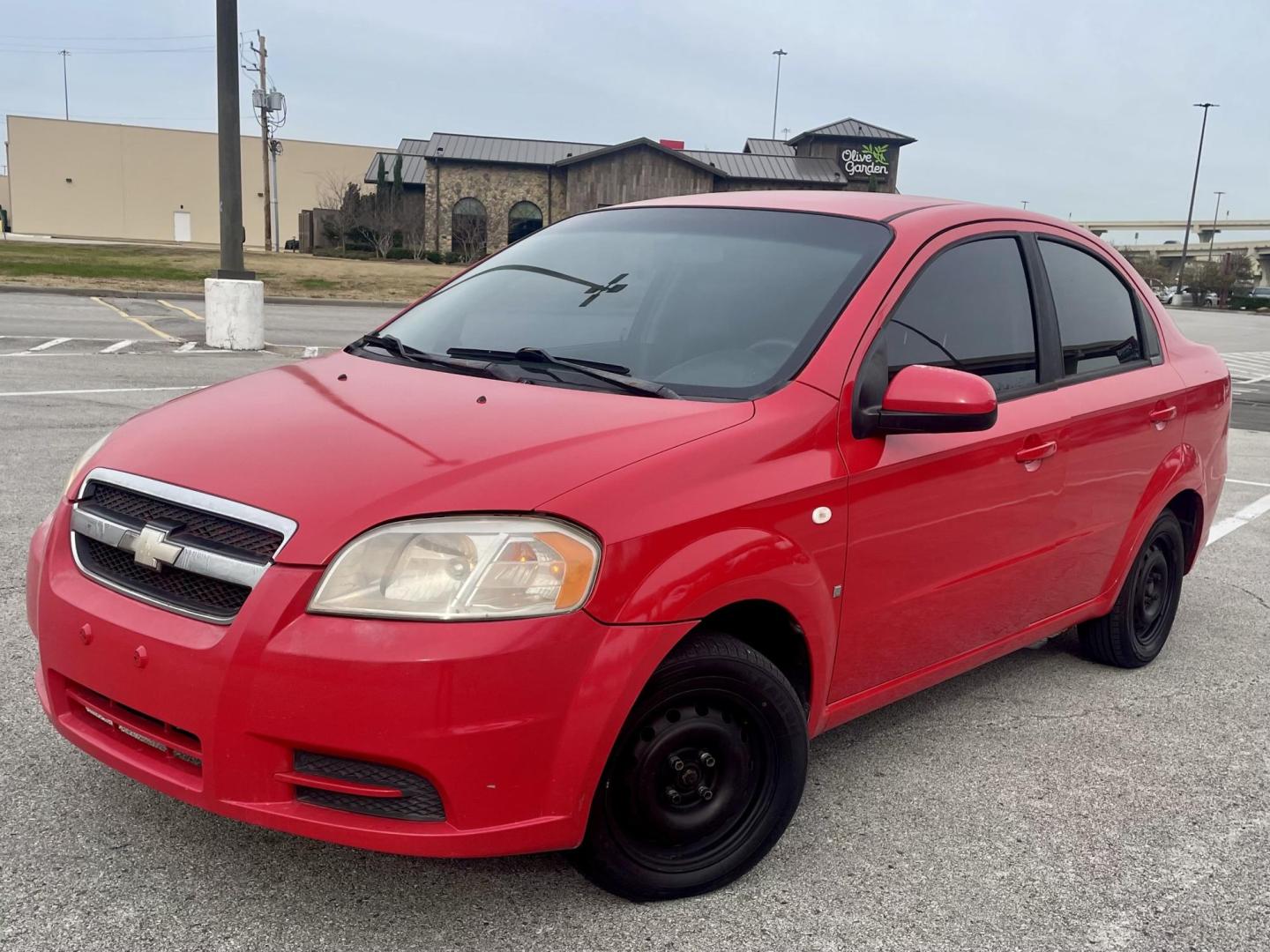 2007 Red Chevrolet Aveo LS 4-Door (KL1TD56657B) with an 2.2L L4 DOHC 16V engine, located at 5005 Telephone Rd., Houston, TX, 77087, (713) 641-0980, 29.690666, -95.298683 - Photo#0