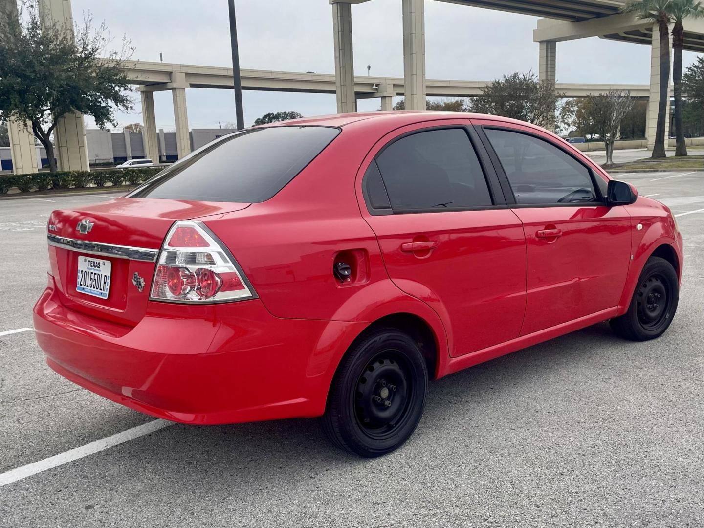2007 Red Chevrolet Aveo LS 4-Door (KL1TD56657B) with an 2.2L L4 DOHC 16V engine, located at 5005 Telephone Rd., Houston, TX, 77087, (713) 641-0980, 29.690666, -95.298683 - Photo#2