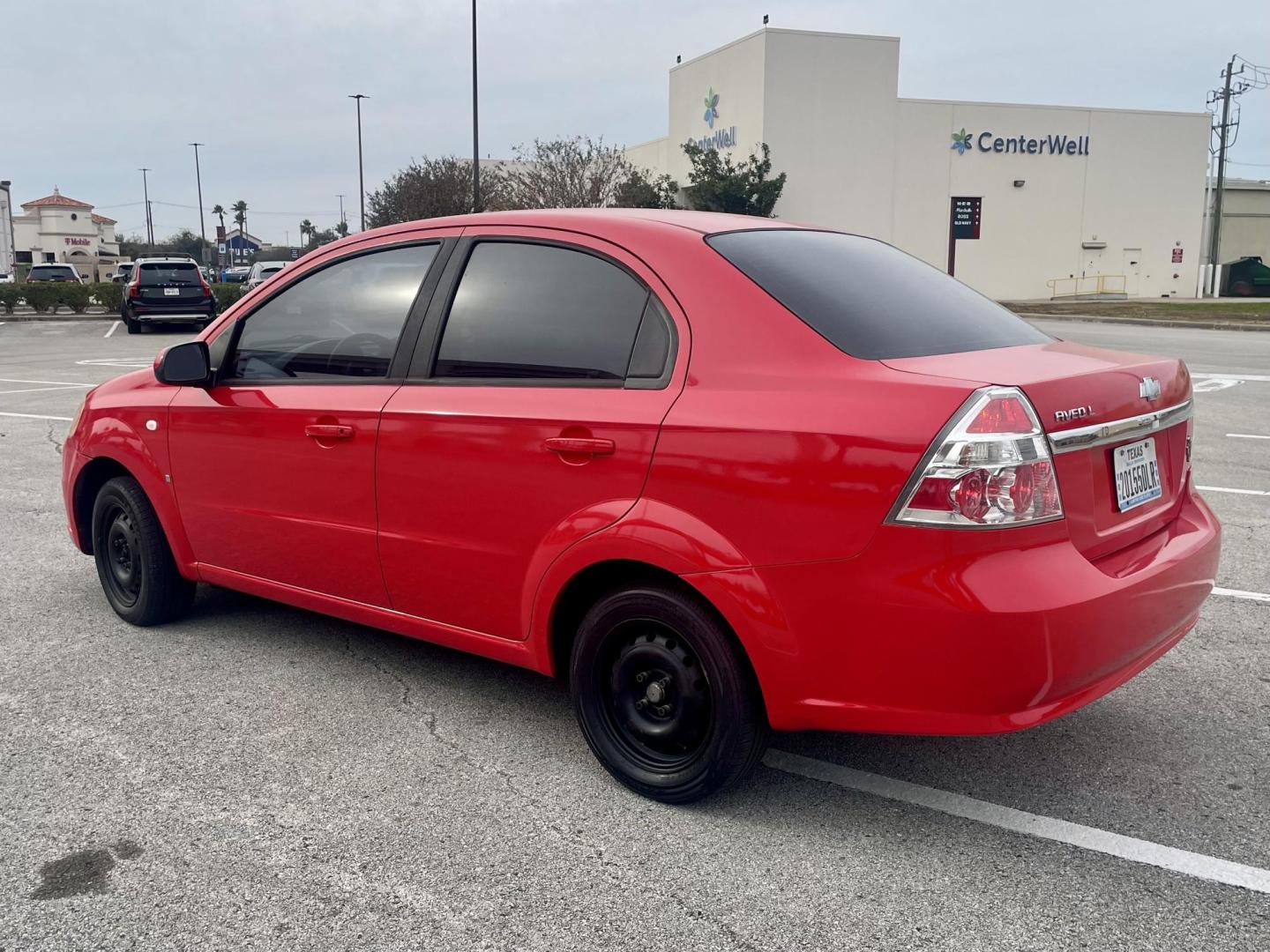2007 Red Chevrolet Aveo LS 4-Door (KL1TD56657B) with an 2.2L L4 DOHC 16V engine, located at 5005 Telephone Rd., Houston, TX, 77087, (713) 641-0980, 29.690666, -95.298683 - Photo#1